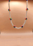 necklace with pearls and polymer claay beads with smiley faces on flowers