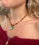 necklace with orange beads ang gold stainless steel centerpiece