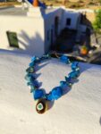 Handmade Necklace with irregularly shaped mother of pearl beads and a stainless  steel 3D teradrop pendant with an eye design