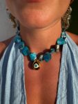 Handmade Necklace with irregularly shaped mother of pearl beads and a stainless  steel 3D teradrop pendant with an eye design