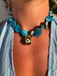 Handmade Necklace with irregularly shaped mother of pearl beads and a stainless  steel 3D teradrop pendant with an eye design