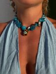 Handmade Necklace with irregularly shaped mother of pearl beads and a stainless  steel 3D teradrop pendant with an eye design